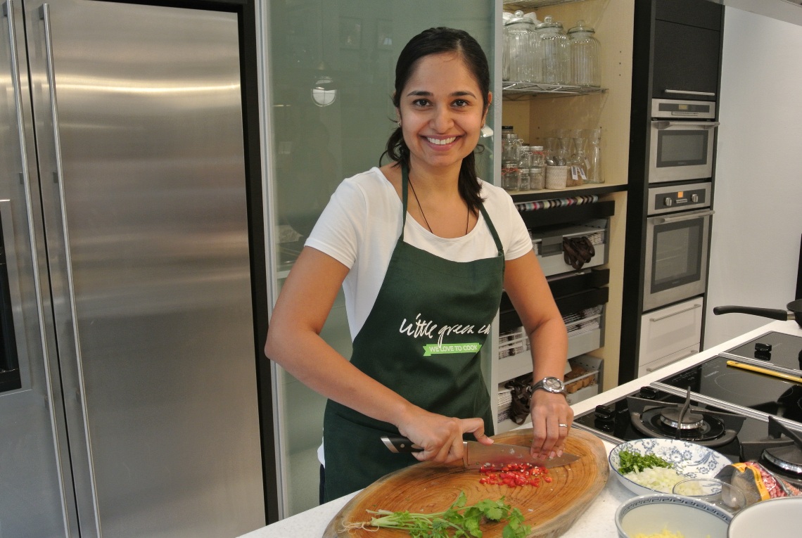 Chef Shula Asnani chopping vegetables in her kitchen